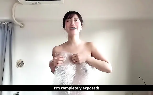 Minami Sally's steamy dildo play beneath crinkling bubble wrap