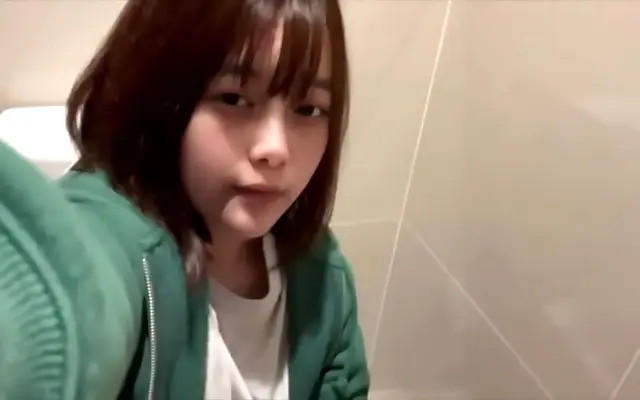 Curvy coed caught in the act during a naughty mall bathroom break